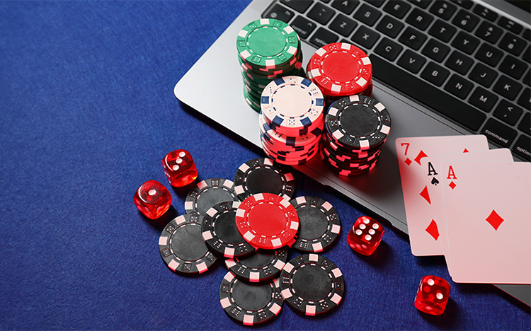 Casino chips, playing cards, laptop