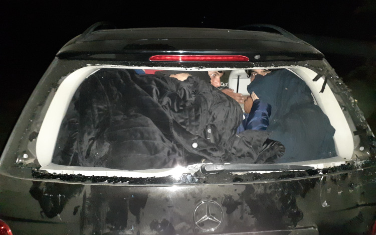 Persons hiding in the back of a car
