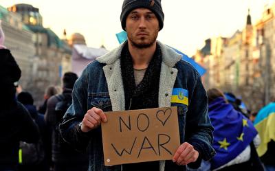 man holding no war sign 
