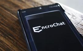 A mobile phone with the EncroChat logo on the screen