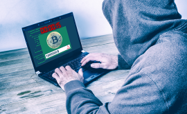 Artistic impression of fraudster in front of laptop