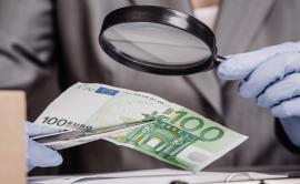 counterfeiting money - banknote inspected