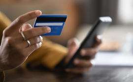 Credit card and phone in hand