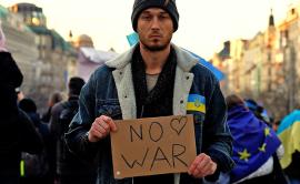 man holding no war sign 