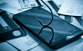 Phone and fishing hook on a desk