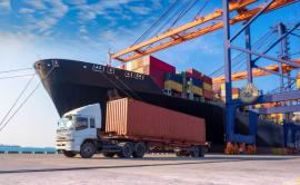 A container ship, cranes and a truck