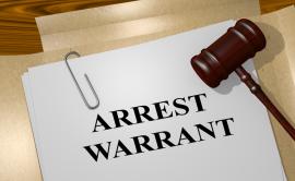 Sheet of paper with words 'Arrest warrant'